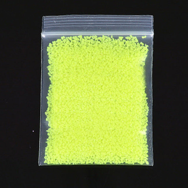 Fluorescent Super luminous Particles glowing in the dark sand